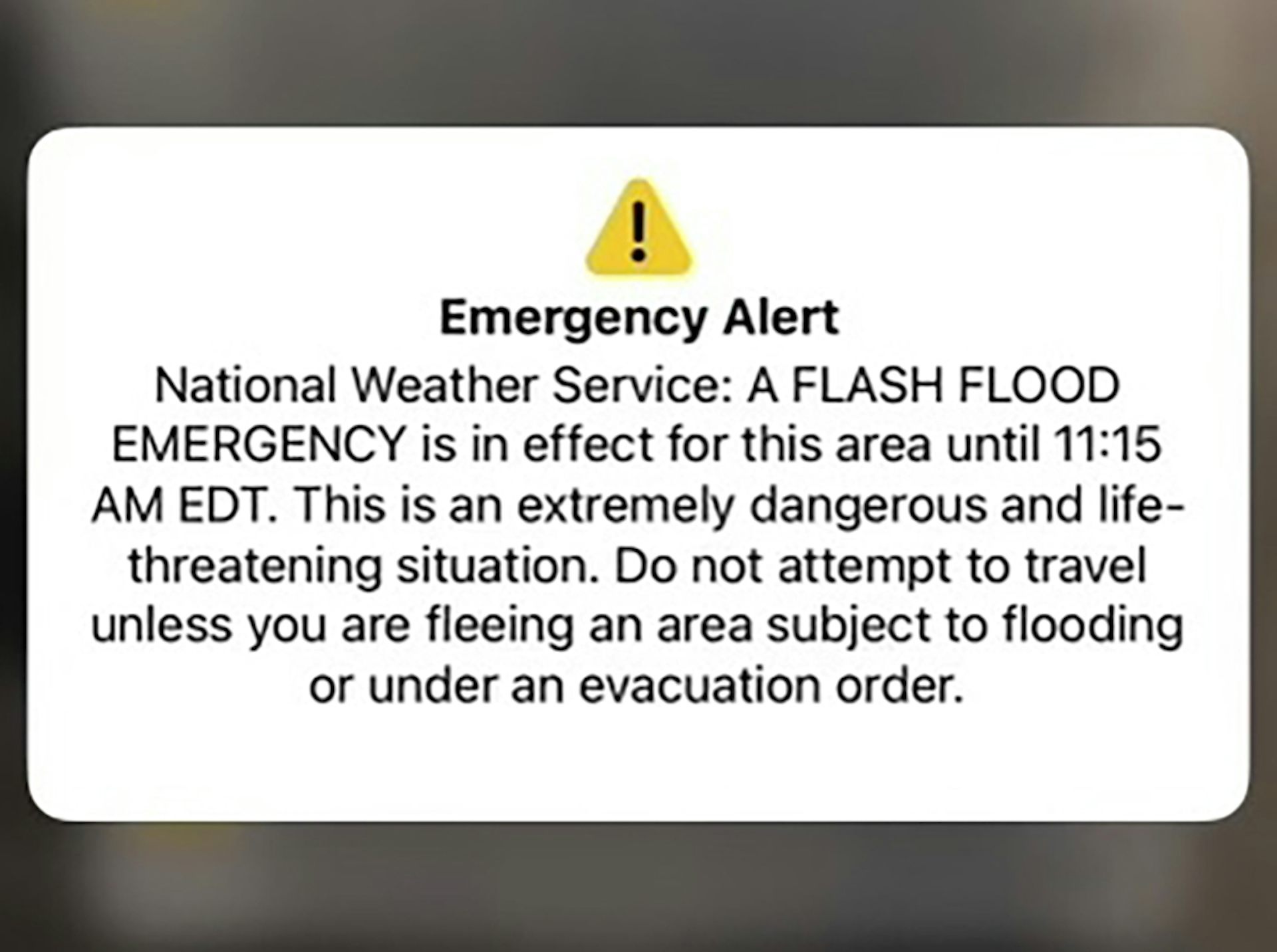 a small yellow triangle enclosing a black exclamation point sits above a block of text a small yellow triangle enclosing a black exclamation point sits above a block of text